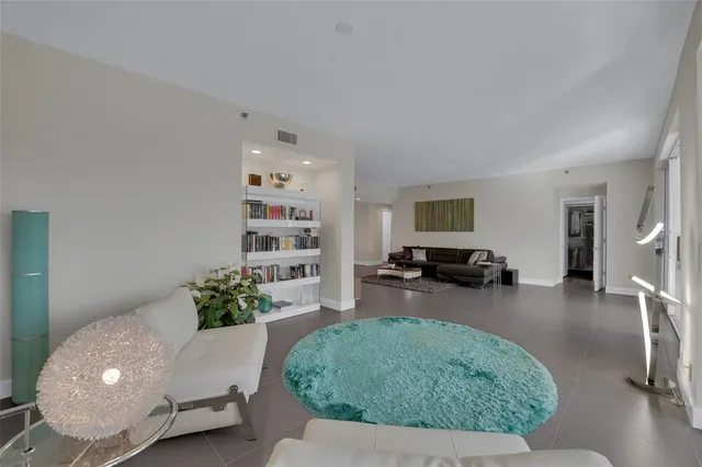 a dining room with furniture and floor to ceiling window