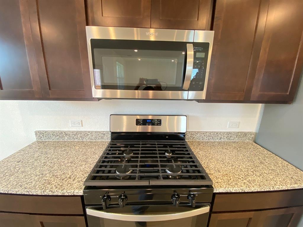 225 Saide Street Georgetown, TX 78626 - Photo 7 of 22 a kitchen with a stove and a microwave