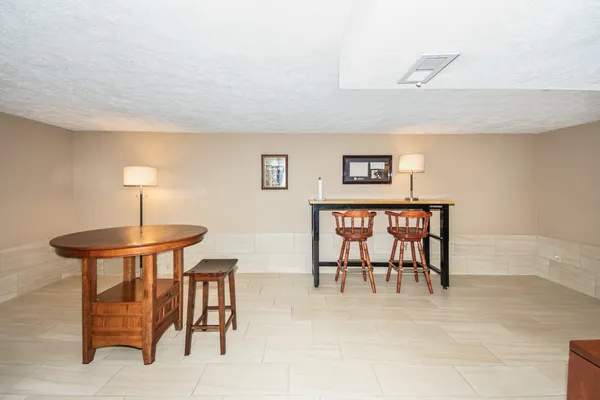 a dining room with furniture and a chandelier