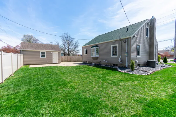 a view of a house with a backyard