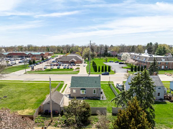 a view of a city with lawn chairs and large trees