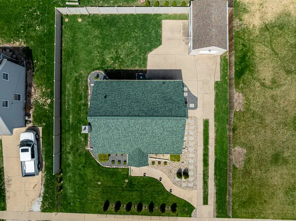an aerial view of a house with a yard and lake view
