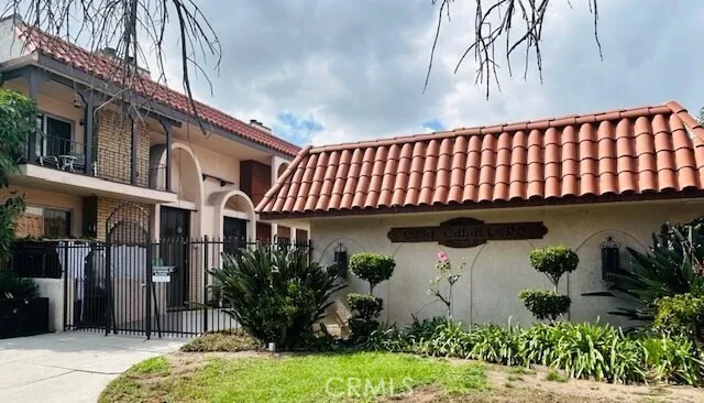 a front view of a house with plants