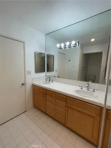 a spacious bathroom with a double vanity sink mirror and shower