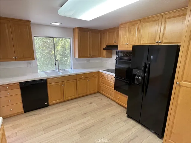 a kitchen with stainless steel appliances granite countertop a refrigerator and sink
