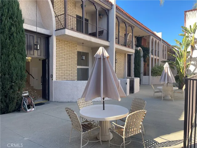 a view of a patio with a table and chairs