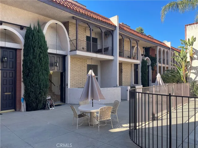 a view of a house with a porch and furniture