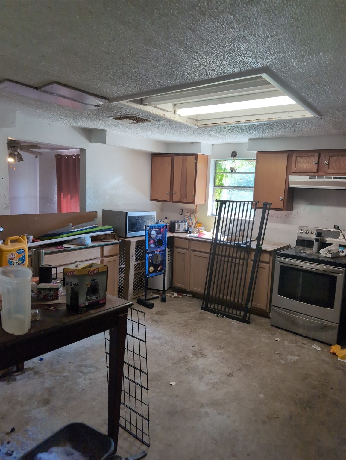 4713 Lake Drive Rosharon, TX 77583 - Photo 3 of 8 a kitchen with stainless steel appliances a stove a microwave and a cabinets