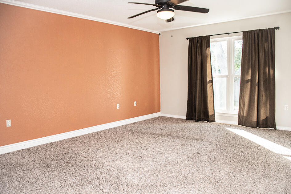 17 8th Avenue Shalimar, FL 32579 - Photo 15 of 25 an empty room with a window and a fan