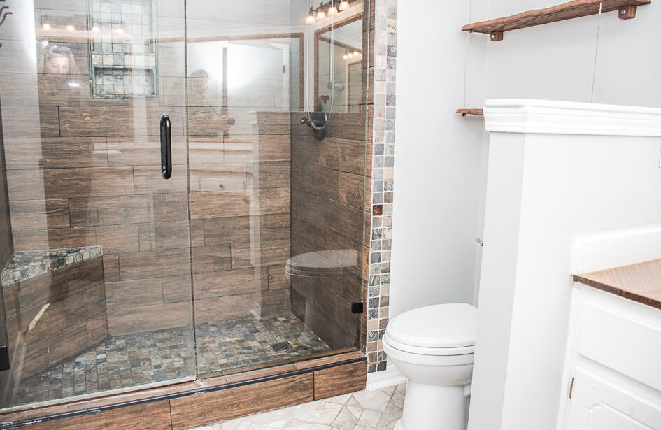 17 8th Avenue Shalimar, FL 32579 - Photo 19 of 25 a bathroom with a shower and toilet