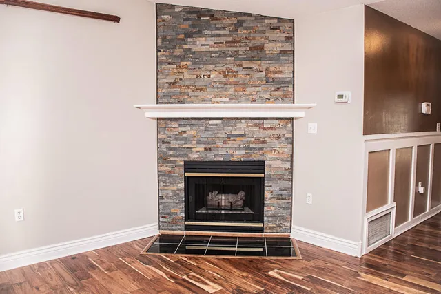 a living room with a fireplace and a wooden floor