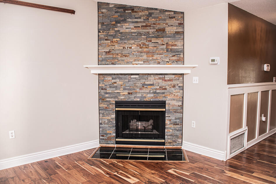 17 8th Avenue Shalimar, FL 32579 - Photo 6 of 25 a living room with a fireplace and a wooden floor