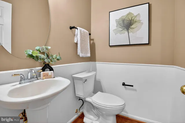 a bathroom with a sink mirror and toilet