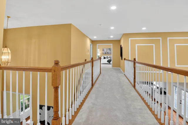 a view of a hallway with wooden floor and door