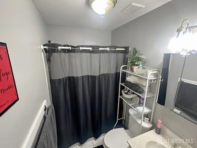 a view of a closet with wooden floor
