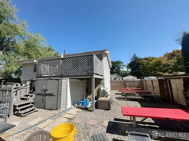 an outdoor sitting area with furniture and wooden floor