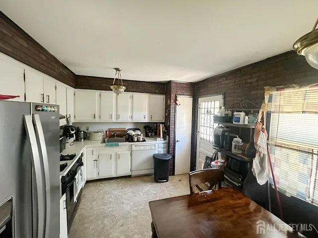 a kitchen with refrigerator and window