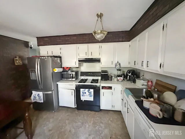 a kitchen with a sink a stove and refrigerator