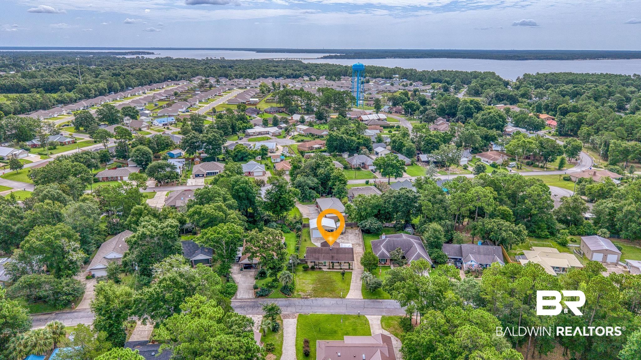 2808 Pine Ridge Drive Lillian, AL 36549 - Photo 31 of 47 Aerial perspective showcasing the residential neighborhood with mature trees and a distant body of water