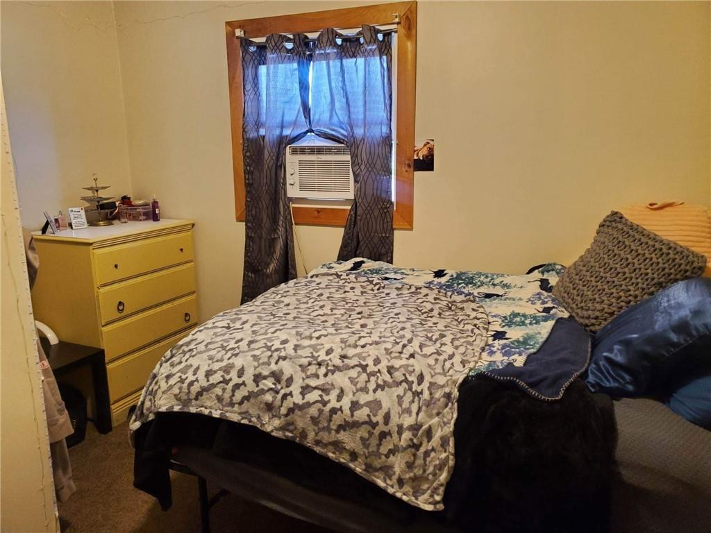 105 Febinger Alley Kittanning, PA 16201 - Photo 17 of 21 a bed sitting in a bedroom next to a window with dresser and mirror