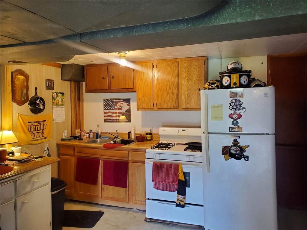 105 Febinger Alley Kittanning, PA 16201 - Photo 18 of 21 a kitchen with stainless steel appliances granite countertop a stove and a sink