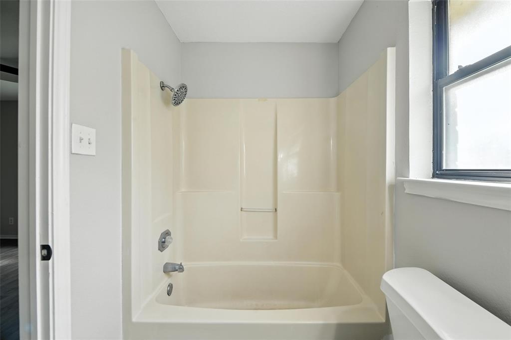 602 Valleyridge Court Decatur, TX 76234 - Photo 23 of 27 a bathroom with a bathtub and a shower