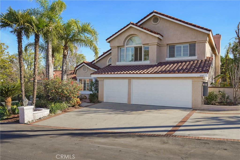 336 South Royal Ridge Drive Anaheim Hills, CA 92807 - Photo 1 of 1 a front view of a house with a yard and garage