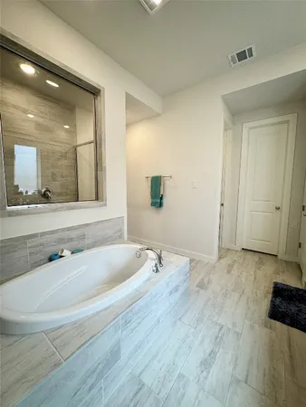 a bathroom with a bathtub and a sink