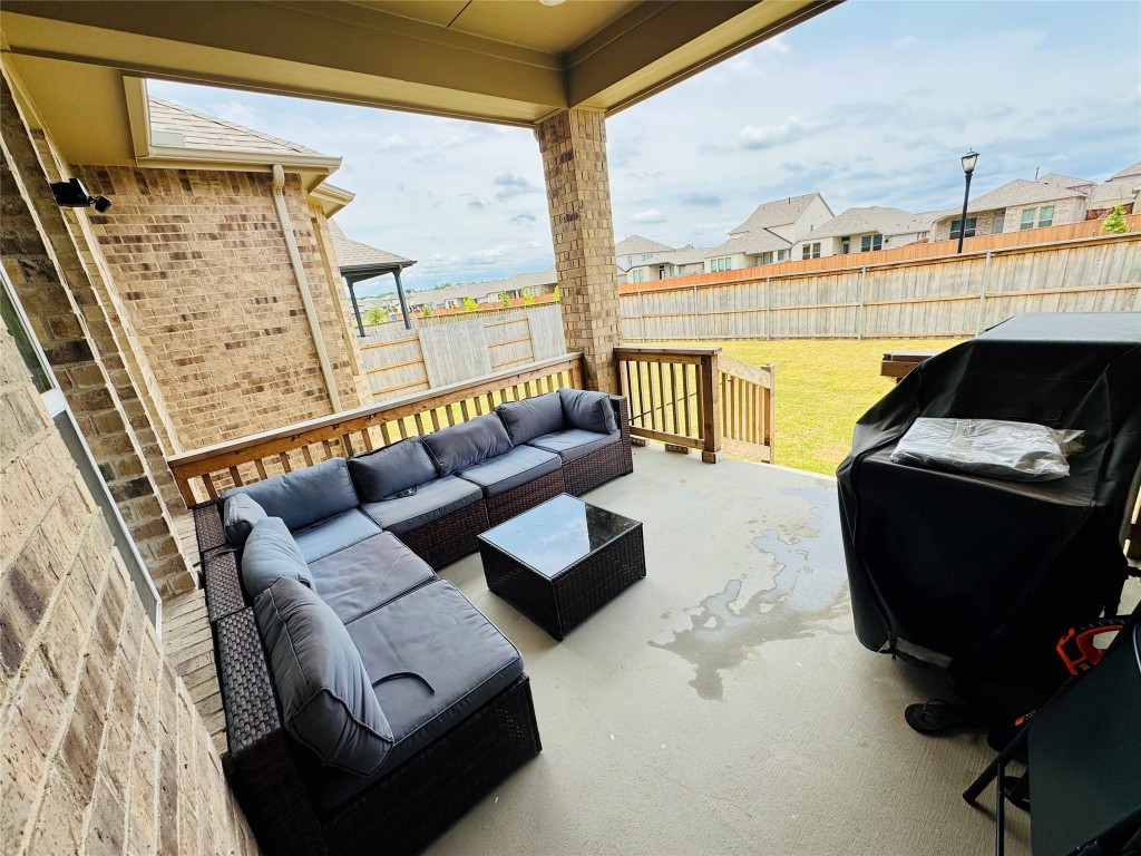 422 Billowing Way Kyle, TX 78640 - Photo 24 of 26 a living room with furniture and a floor to ceiling window