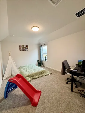 a bedroom with a bed and a desk