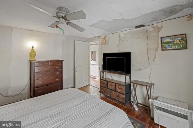 a bedroom with a bed and a television