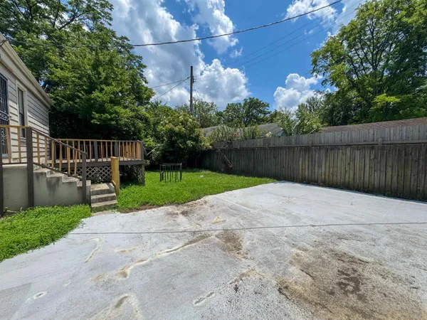 a view of backyard with swimming pool and green space