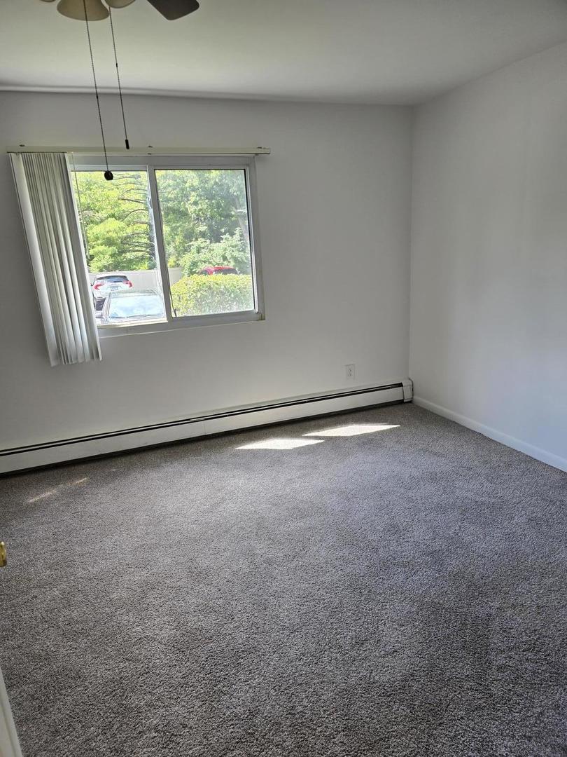 19360 Wolf Road, Unit 1 Mokena, IL 60448 - Photo 8 of 11 a view of an empty room with a window
