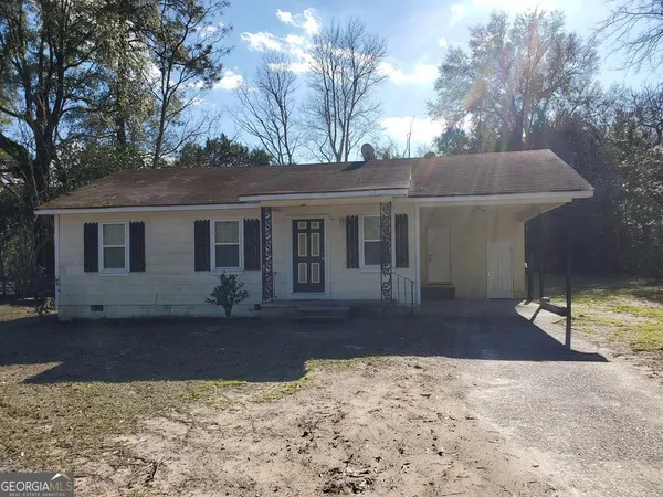 a front view of a house with a yard covered in snow