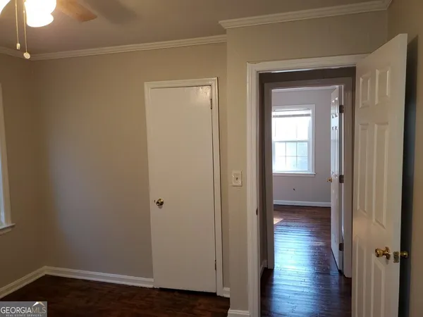a view of a hallway with wooden floor