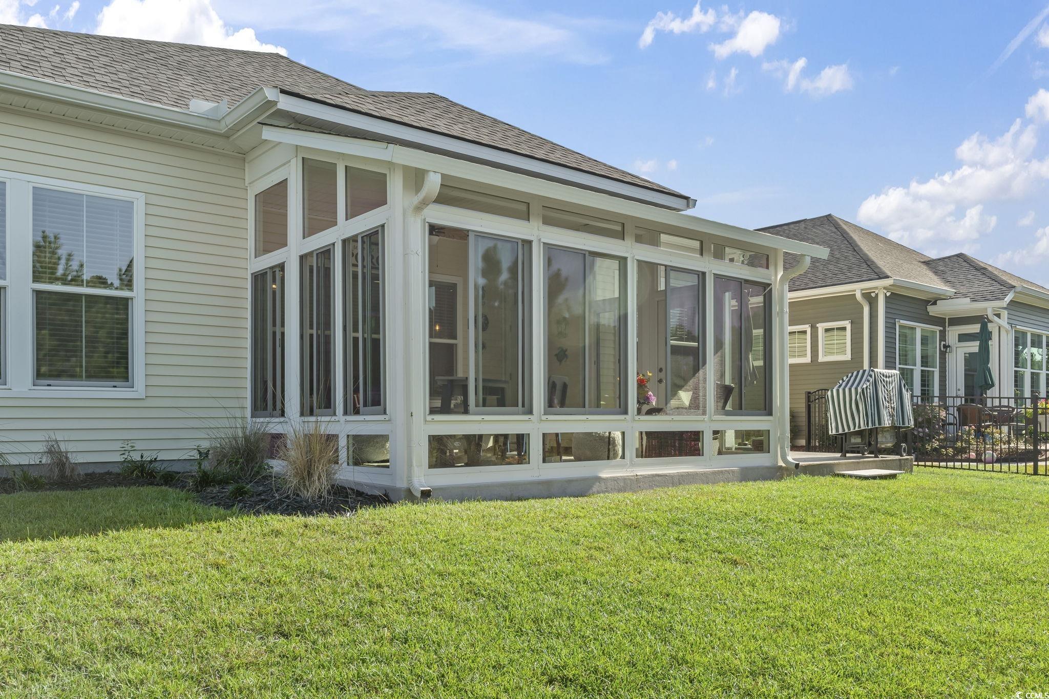 256 Yellow Rail Street Murrells Inlet, SC 29576 - Photo 34 of 40 View of home's exterior with a lawn and a sunroom
