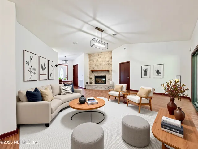 a living room with furniture fireplace and window