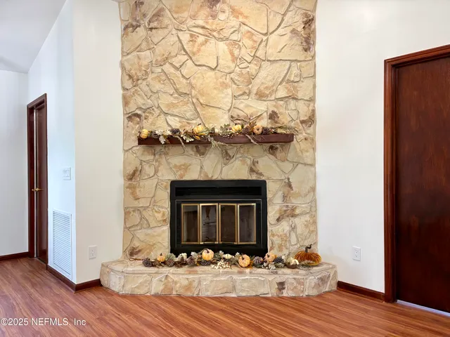 a view of fireplace and wooden floor