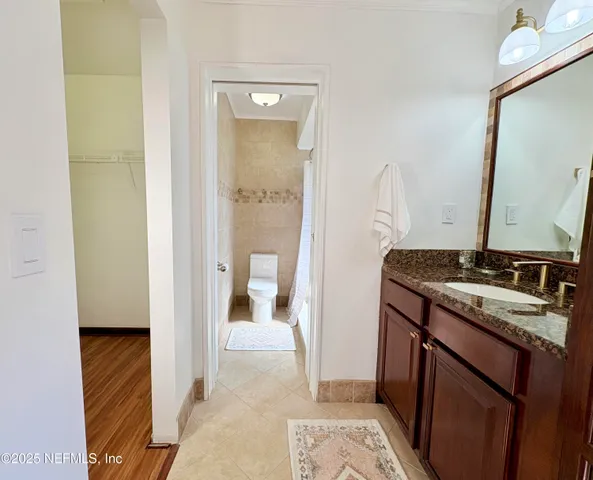 a bathroom with a granite countertop sink a mirror and a shower