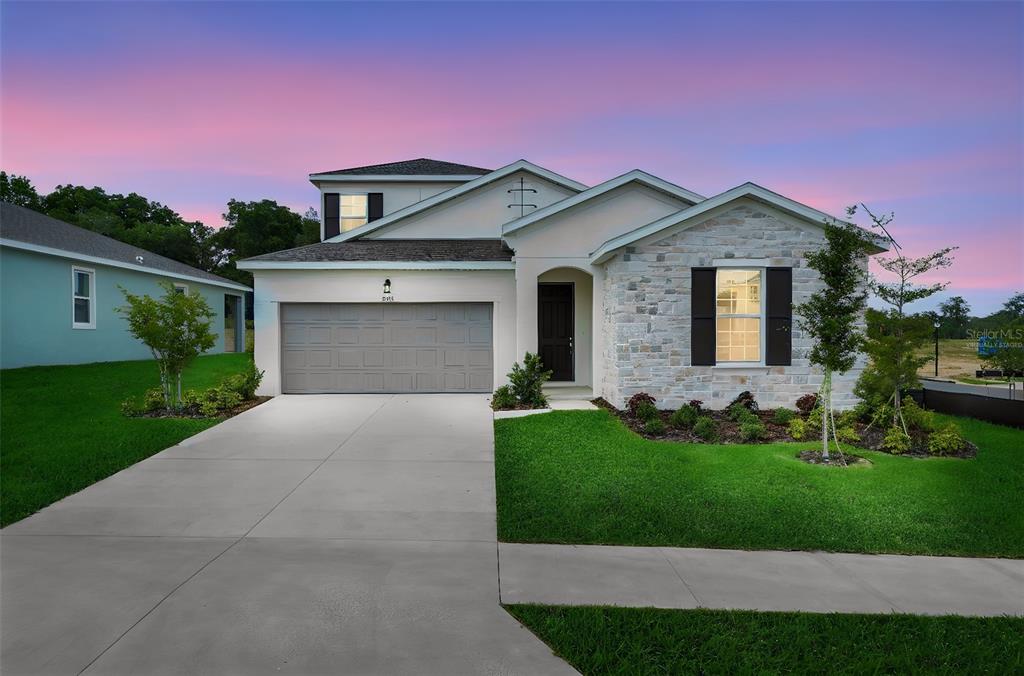 35163 Tuscan Hill Road Dade City, FL 33525 - Photo 1 of 45 a front view of a house with a yard and garage