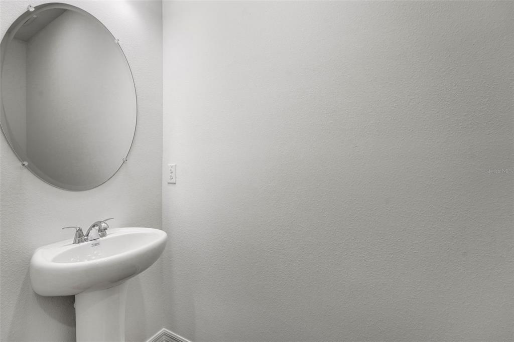 35163 Tuscan Hill Road Dade City, FL 33525 - Photo 14 of 45 a bathroom with a sink and mirror