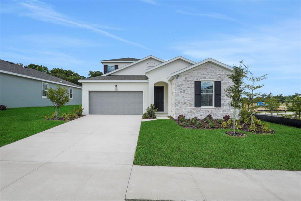 35163 Tuscan Hill Road Dade City, FL 33525 - Photo 3 of 45 a front view of a house with a yard