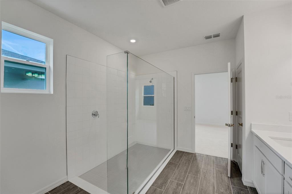 35163 Tuscan Hill Road Dade City, FL 33525 - Photo 33 of 45 a bathroom with a shower and a tub