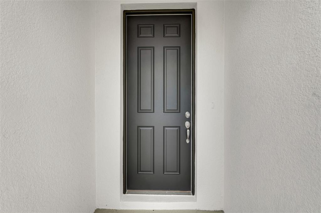 35163 Tuscan Hill Road Dade City, FL 33525 - Photo 4 of 45 a view of a hallway with wooden door