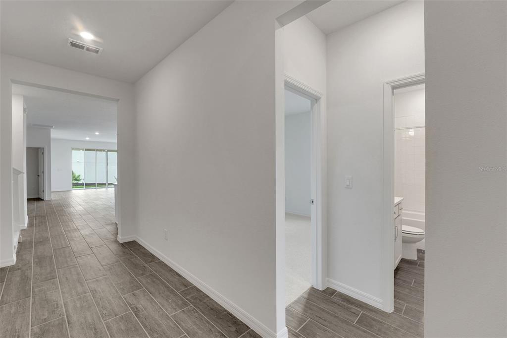 35163 Tuscan Hill Road Dade City, FL 33525 - Photo 5 of 45 a view of a hallway with wooden floor
