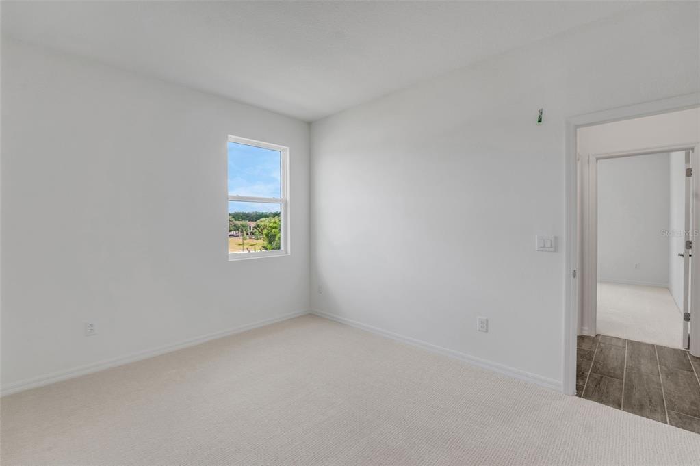 35163 Tuscan Hill Road Dade City, FL 33525 - Photo 7 of 45 a view of an empty room with a window