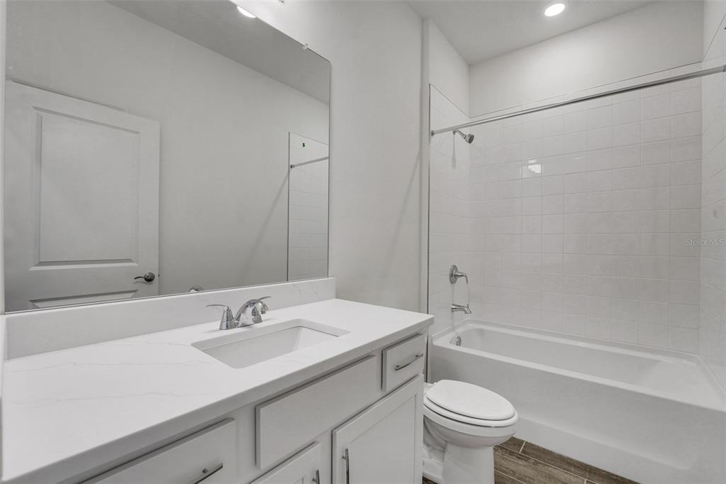 35163 Tuscan Hill Road Dade City, FL 33525 - Photo 10 of 45 a bathroom with a sink toilet vanity and shower