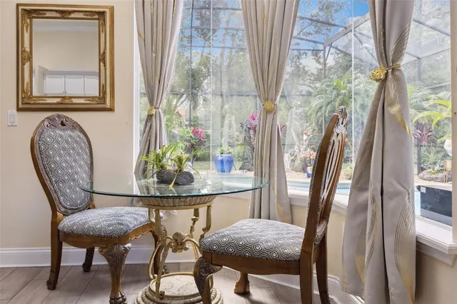 a view of a dining room with furniture and a window