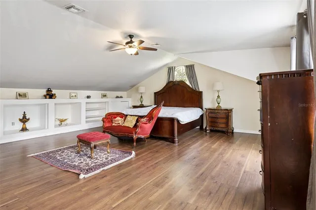 a view of a big house with a big yard and large trees