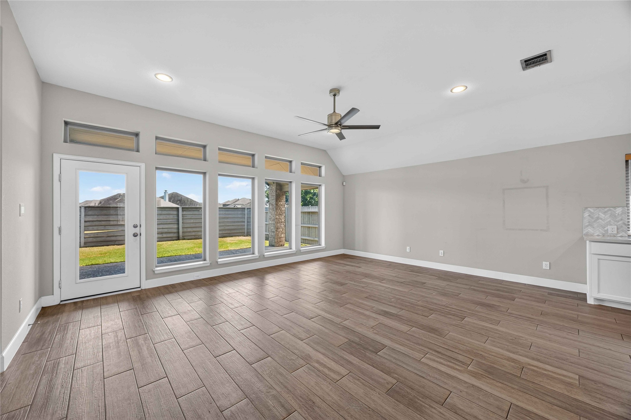 4333 Arbor Crest Lane Manvel, TX 77578 - Photo 7 of 40 A striking wall of oversized windows fills this spacious living area with daylight, centering the room around expansive views and a glass-paneled door that opens directly to the rear grounds.